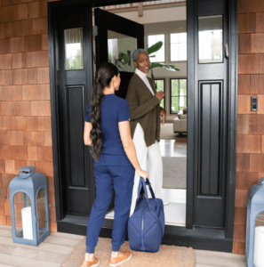 sollis health employee being welcomed into home by patient, making a house call
