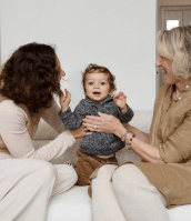 mother and grandmother holding child smiling at camera, sollis pediatrics