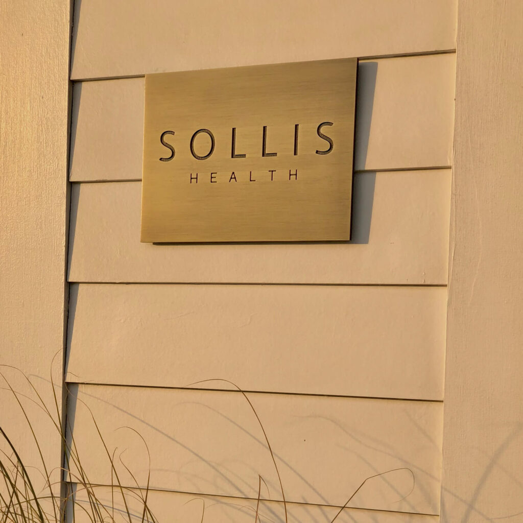 sollis health sign on exterior wall in sunset